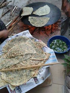 there are several pita breads on the table