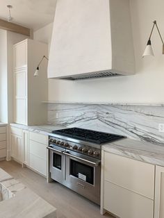 a stove top oven sitting inside of a kitchen next to an oven and countertop