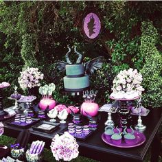 a table topped with purple and black desserts