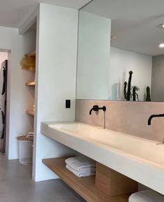 a bathroom with two sinks and mirrors in it