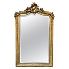 an ornate gold framed mirror on a white background