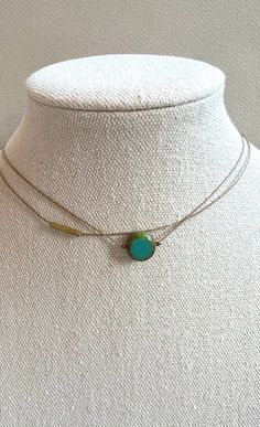 "Simple chic. Features a small teal colored glass bead, vintage brass bead, beige nylon cord. The necklace is 14\" with a 2\" extension. The necklace will be gift boxed." Dainty Double Strand Adjustable Layered Necklace, Adjustable Dainty Choker For Layering, Adjustable Minimalist Multi-strand Layered Necklace, Dainty Adjustable Layered Necklaces, Dainty Layered Adjustable Necklaces, Adjustable Layered Necklace With Delicate Chain, Handmade Adjustable Layered Necklace, Adjustable Multi-strand Brass Necklace, Green Jewelry With Delicate Chain For Layering