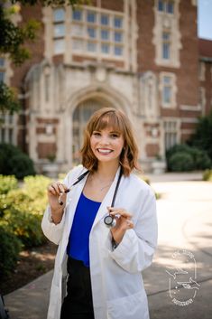 a woman in white lab coat holding a stethoscope and smiling at the camera