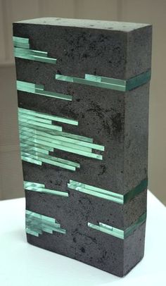 a black and green object sitting on top of a white table next to a wall