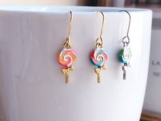 These are delicate enamel lollipop earrings which are perfect gift for kids and friends. They are made from the following: (1) Gold plated / silver plated double-sided enamel lollipop charm (Size: 16 x 7 mm) (2) Gold plated / silver plated earring hooks ✏️ Please choose your desired plating and color of the earrings 🍭 Necklace 🍭 -> https://www.etsy.com/listing/937269407 【ADDITIONAL QUANTITY】 Kindly convo us if you require additional quantity and we will be happy to customize the order to me Playful Nickel-free Earrings For Birthday, Sweet Multicolor Earrings For Gift, Fun Enamel Earrings For Gifts, Playful Personalized Earrings For Gifts, Personalized Playful Earrings For Birthday, Playful Personalized Earrings For Birthday, Playful Enamel Earrings As Gift, Playful Personalized Multicolor Earrings, Playful Multicolor Personalized Earrings