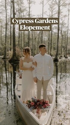 a man and woman standing in a boat on the water