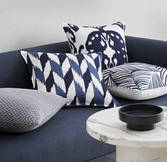 a blue and white couch with pillows on it