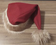 Have you looked at a sad boring Santa hat and wished you could have something more exciting? Well, now you can!  **No Embroidery** I have a selection of Velvet Fabric colors, as well as a wide array of Fur Trims to choose from! Just make your selections and let me know what your hat size is. Just measure over your ears (or behind them, if you prefer) and down low at the back of your head. Most adults should be about 22-24 inches around on average. Some people have smaller (especially children) or larger heads. The actual size may vary a bit due to the different fur thickness/length, but your hat should still fit no problem! So just let me know and I'll purchase the fabric and put your hat together as soon as I receive it! It should be complete within the next few days (unless I have other Trim Styles, Costume Hats, Wool Fabric, Santa Hat, Hat Sizes, Fur Trim, Velvet Fabric, Costume Accessories, Fabric Color