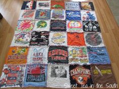 there is a large quilt made out of t - shirts on the floor