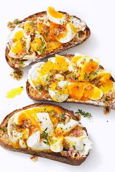 three pieces of bread with eggs and herbs on them