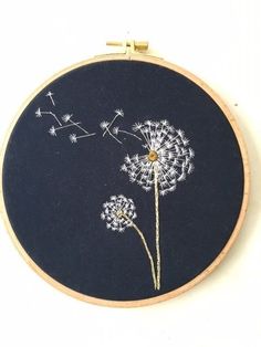 the embroidery on the hoop has dandelions in it