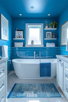 a bathroom with blue walls and white fixtures, including a bathtub in the center