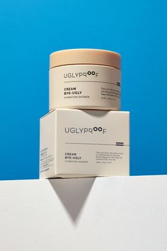 two creams stacked on top of each other in front of a blue wall with the words uglyprop