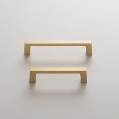 two wooden handles on a white wall