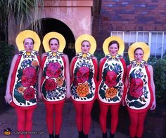 five women in matching outfits with yellow hats