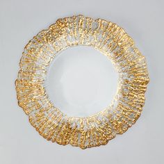 a white and gold plate sitting on top of a table