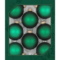 six green christmas ornaments in a box