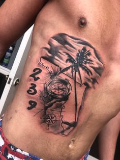 a man with a tattoo on his stomach has a clock and palm tree in the background