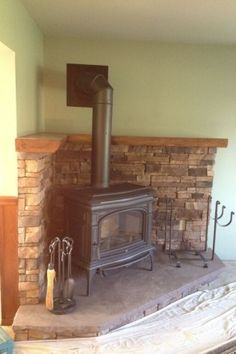 a wood burning stove sitting inside of a living room next to a fire hydrant