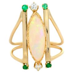 –Stone(s)– (1) Natural Genuine Opal - Marquise Navette Cut - Heart Prong Set - White Base w/ Green Purple Orange Color Play  - 15.17 x 5.8mm (approx.) (2) Natural Genuine Diamond - Round Brilliant Cut - Prong Set - White Color - 2.6mm (approx.) (4) Natural Genuine Emerald - Round Brilliant Cut - Prong Set - Medium Green Color - 2.0mm (approx.) Material: 14k Yellow Gold Weight: 4.17 Grams Ring Size: 6.5 ( fitted on finger, please contact us prior to purchase with sizing inquiries) Ring Width: 22. Yellow Gold Cocktail Ring, Opal Wedding Rings, Marquise Ring, Emerald Diamond Ring, Gold Cocktail Ring, Color Play, Gold Cocktail, Diamond Cocktail Rings, Modern Ring