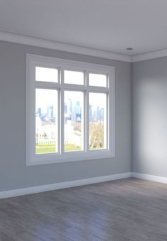 an empty room with large windows and hard wood flooring