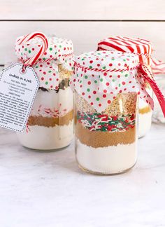 two jars filled with cookies and candy canes