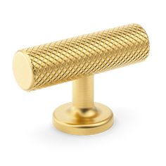 a gold knob with a round design on the front and back end, is shown