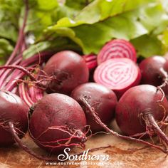 beets and greens on a wooden cutting board