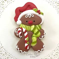 a cookie decorated like a ginger with a candy cane