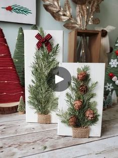 three christmas cards with pine cones and evergreens on them, sitting on a table