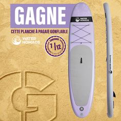 a purple surfboard sitting on top of sand next to a sticker that says gagne