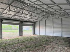 an empty garage with grass in the foreground