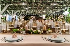 the tables are set with white linens and place settings for an elegant wedding reception