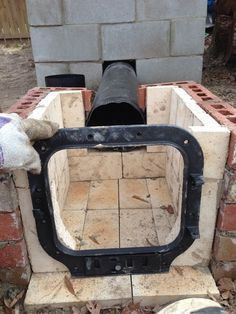 an old brick oven is being built into the ground