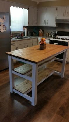 a kitchen with an island made out of wood