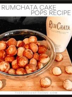 a glass bowl filled with cinnamon rolls next to a bottle of rumchata cake pops recipe