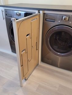 an open door to a washer and dryer in a room