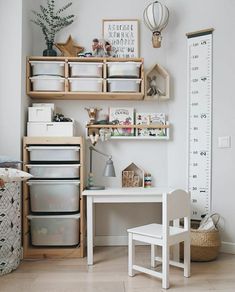 a child's room with white walls and wooden shelves