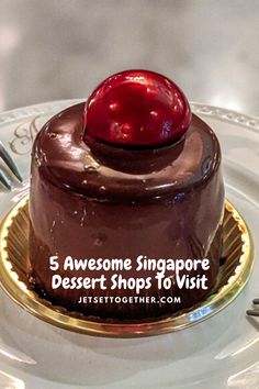 there is a chocolate cake with a cherry on top and the words 5 awesome singapore dessert shops to visit