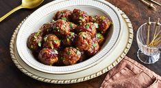 a bowl filled with meatballs on top of a wooden table