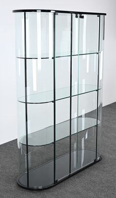 a glass display case sitting on top of a carpeted floor next to a white wall