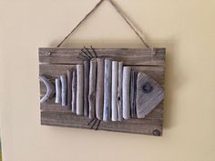 a wooden sign with books on it hanging from a wall