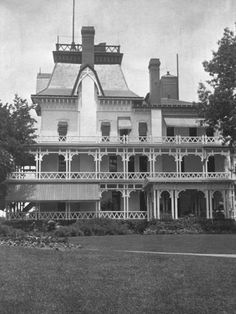 an old black and white photo of a large house