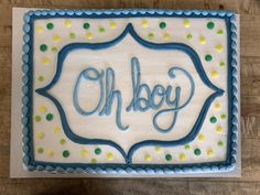 a sheet cake with the word oh boy on it and polka dots in blue icing