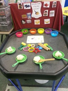 the table is set up with different kinds of utensils and spoons on it