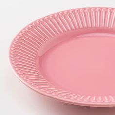 a pink plate on a white surface with lines in the middle and one line at the bottom