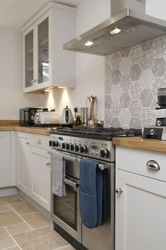 a stove top oven sitting inside of a kitchen