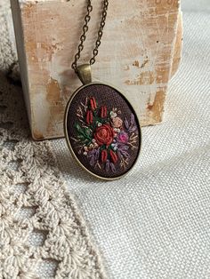 "This pendant is hand embroidered. Ready for shipment. Pendant size: 50x32mm  / 1,97\"x1,26\" Chain Length: 68,58 cm / 27\"   (default, I can change the length of the chain) Clasp:  Surface of embroidery is protected from moisture and dirt by professional impregnate. oooooo See more of my embroidered necklaces: https://www.etsy.com/shop/EmbroideredJewerly?ref=hdr_shop_menu§ion_id=19106264 Back to shop: https://www.etsy.com/shop/EmbroideredJewerly?ref=hdr_shop_menu All designs by Marta. Please do not copy." Embroidered Necklaces, Hand Embroidered Pendant, Embroidered Pendant, Embroidered Necklace, Luxury Necklace, Locket Necklace, Flower Necklace, Chain Length, Locket