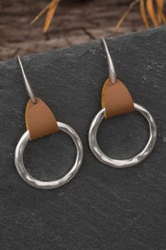 Upgrade your accessory game with these stylish Hammered Circle Earrings. Made with a combination of tan leather and silver circle, these earrings will add a touch of elegance to any outfit. Perfect for a professional or casual look. 2" Drop Metal Drop, Silver Statement Earrings, Oval Earring, Round Decor, Antique Earrings, Circle Earrings, Round Earrings, Leather Earrings, Initial Necklace