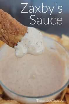 a close up of a plate of food with sauce on it and a cracker in the middle